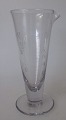 Measuring 
glass, 19th 
century. Clear 
glass. With 
grinding and 
etching. Height 
.: 12,2 cm.