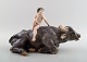 Rare Royal 
Copenhagen 
figure, naked 
boy on water 
buffalo.
Model number 
1849.
Measures 30 
cm. X ...