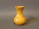 Small ceramic 
vase with a 
yellow glaze.
H - 10,5 cm 
and Dia - 6,5 
cm.