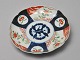Japanese Imari 
porcelain 
plate, 19th 
century. 
Decorated with 
plant 
ornamentation. 
Diameter: 22 
cm.
