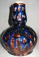 Bottle with 
cork in clay, 
Denmark, 
approx. 1900. 
Decorated in 
brown and blue 
colors. H: 19 
cm. ...