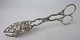 Cake pliers in 
silver, rococo 
pattern. 20th 
century. 
Stamped: 830 s. 
Length: 13 cm.