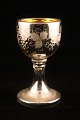1800th century 
wine glass made 
of mercury 
glass, 
decorated with 
etched wine 
leaves outside. 
...