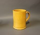Ceramic jug in 
yellow glaze by 
an unknown 
artist.
H - 15 cm and 
Dia - 11 cm.