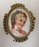 French porcelain brooch, Limoges, 19th century. France. Hand decorated with a young woman. With ...