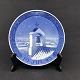 Diameter 18 cm.
The plate was 
designed by 
Niels Thorsson.
Motif: Bell 
tower on church 
roof.
