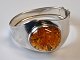 Sterling 
bracelet with 
polished amber 
with seeds, 
20th century. 
Stamped. With 
lock. Inside 
...
