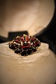 Old brooch with beautiful red grenades. Measures: 3x2cm.
