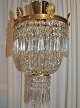 Crystal crown 
with bronze 
fitting, 
19./20. with 
bronze palms. 
With 480 
prisms. H: 50 
cm. Dia: 28 cm.