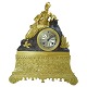 A French clock of gilt bronze, neo-rococo.Watch  in brown patinated bronze with a lying ...
