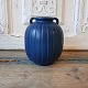 Ipsen's ribbed 
vase with blue 
glaze 
Height 14 cm.