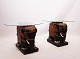 A pair of 
sidetables with 
glass plate and 
bottom of 
chinese 
elephants of 
orignal painted 
wood ...