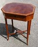 Empire sewing 
table, c. 1820. 
In mahogany 
with inlaid 
fruitwood. 
Hexagonal 
plate. With 
four ...