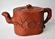 Signed Chinese 
tea pot, red 
clay, 20th 
century. 
Decorated with 
branches and 
flowers. L: 19 
cm. ...