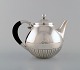 Johan Rohde for 
Georg Jensen. 
"Kosmos" teapot 
in sterling 
silver with 
ebony handle. 
Design ...