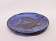 Large round 
ceramic dish 
with dark blue 
glaze and motif 
of a fish, by 
Pottemagerstuen 
at ...
