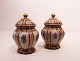 A pair of 
lidded jars of 
stoneware by 
Dahl Jensen. 
The jars are in 
great vintage 
condition.
H - ...