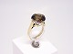 Ring of 14 ct. 
gold decorated 
with a large 
smoky quarts 
and stamped ESC 
P.
Size - 56.