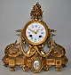 French ormelu mantel clock, 19th century Rococo style. Decoration with procelain plaque with ...
