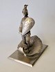 Antique letter 
weight, 19th 
century. A man 
with a shield 
in a clam 
shell. Metal. H 
,; 14 cm.