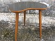 Small kidney 
shaped table 
with black 
formica plate 
and slightly 
inclined legs. 
Dimensions: 
HxWxD ...