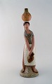 Lladro, Spain. 
Large figure in 
glazed 
ceramics. Woman 
carrying water. 
Late 20th ...