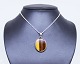 Pendant of 925 
sterling silver 
and 
brown/yellow 
stone stamped 
N.E. From. The 
jewlery is in 
great ...