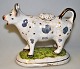 Faience cream 
cow, 19th 
century, 
England. White 
glazed, with 
spots in luster 
and gilding. 
Foot ...