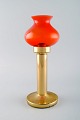 HANS-AGNE 
JAKOBSSON for A 
/ B MARKARYD. 
Oil lamps in 
brass and red 
art glass. 1960 
/ ...