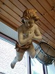 Large putto of 
carved and 
painted 
wood19th 
century. Length 
85cm.