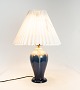 Table lamp of 
ceramic with 
dark blue glaze 
by Michael 
Andersen and 
Son. The shade 
is handfolded 
...