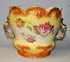 Faience 
flowerpot 1880 
- 1900. 
England. Yellow 
decorated with 
roses in 
transfer 
technique. With 
...