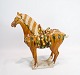 Large ceramic 
horse glazed in 
dark yellow 
nuances from 
China around 
the 1920s. The 
horse is in ...