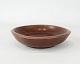 Ceramic bowl in 
dark red no.: 
2650 by Niels 
Thorson for 
Aluminia.
4,5 x 19 cm.