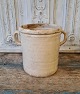 Beautiful old 
earthenware jar 
with beautiful 
cream-colored 
glaze. Appears 
with glaze 
defects on ...