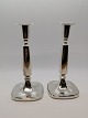 A pair of 
Swedish table 
tops of silver 
height 18cm. A 
candlestick 
with a small 
print on the 
base ...