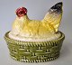 Faience hen, 
19th century 
Germany. 
Polychrome 
decorated. 
Braided nest of 
greenish glaze. 
With ...
