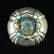 An early Georg 
Jensen 
jewellery. 
Georg Jensen; 
A silver brooch 
set with a 
labradorite and 
...