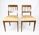 A pair of 
dining room 
chairs of 
mahogany with 
inlaid wood 
upholstered 
with light 
fabric from the 
...