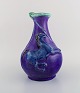 European studio ceramicist. Unique vase in glazed ceramics. Lion and unicorn on 
purple background. Late 20th century.
