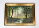 Oil painting 
with forrest 
motif and 
gilded frame.
65 x 88 x 5 
cm.