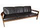 The 
three-seater 
sofa in teak 
and black 
leather, 
designed by 
Arne Vodder and 
manufactured by 
...