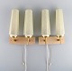 Scandinavian designer. A pair of double brass wall lamps with glass shades. Mid-20th ...