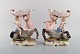 A pair of 
antique 
figurative 
Meissen 
compotes in 
hand-painted 
porcelain. Puti 
on centaur ...