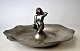 Hammered 
ashtray in 
pewter with 
naked woman, 
1930s, Denmark. 
Kronetin. 
Stamped. H .: 9 
cm. Dia: ...