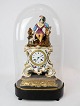 French table clock with glass dome and decorated with figure of porcelain from 1860. The clock ...