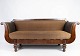 Antique sofa upholstered with brown fabric and frame of dark wood from 1860. The sofa is in ...