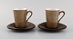 Kenji Fujita 
for Tackett 
Associates. Two 
porcelain 
coffee cups 
with saucers. 
Dated 1953-56.
The ...