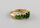 Scandinavian jeweler. Vintage alliance in 8 carat gold adorned with green 
semi-precious stones. Mid-20th century.

