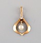 Scandinavian 
jeweler. 
Classic pendant 
in 14 carat 
gold with 
cultured pearl. 
Mid-20th ...